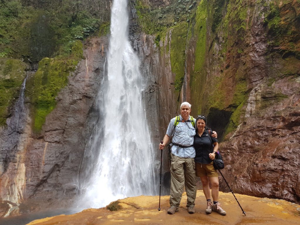 Veronica and Asaf next to the spectacular Toro Waterfall in Costa Rica